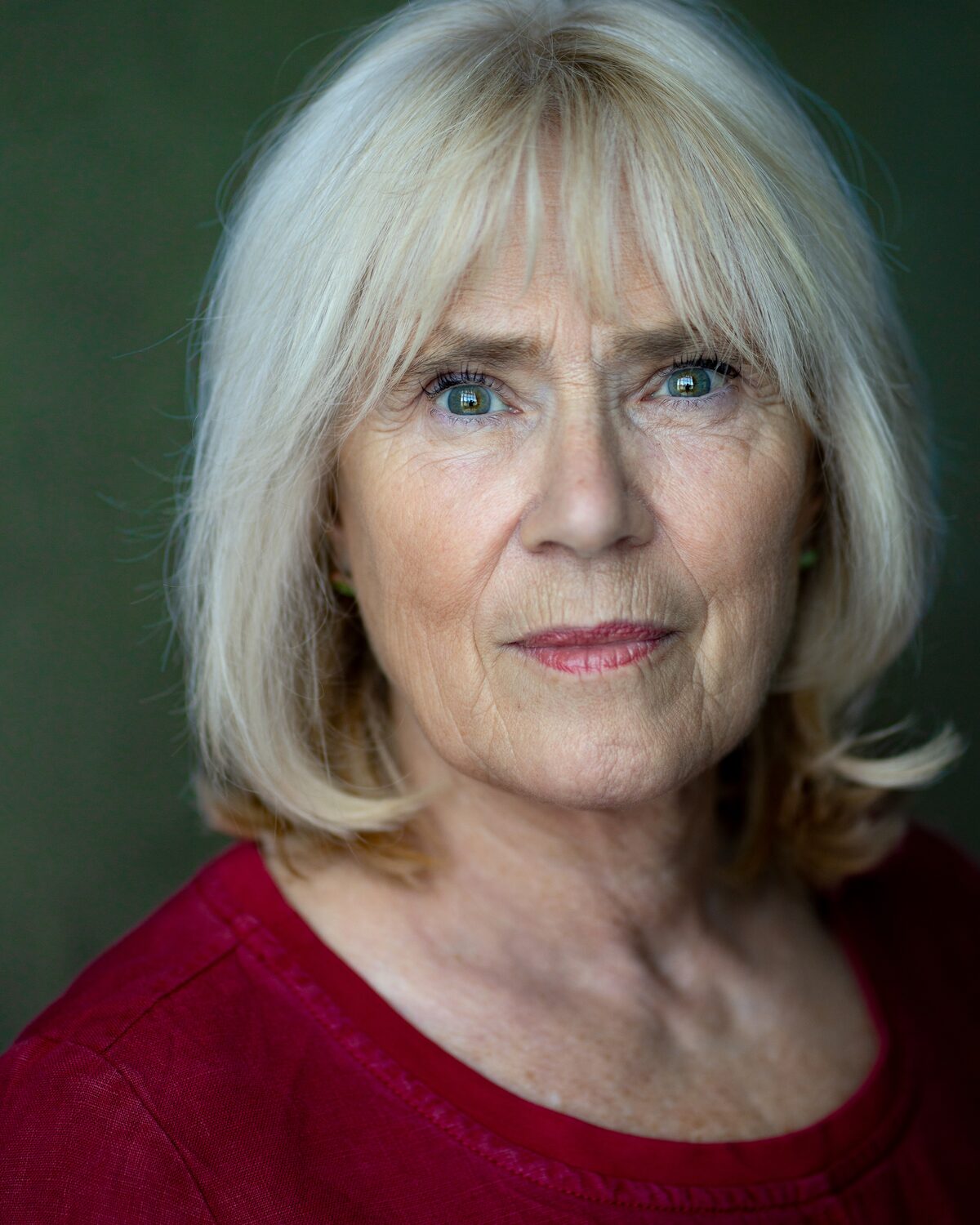 Headshot of Maggie Saunders in a red top